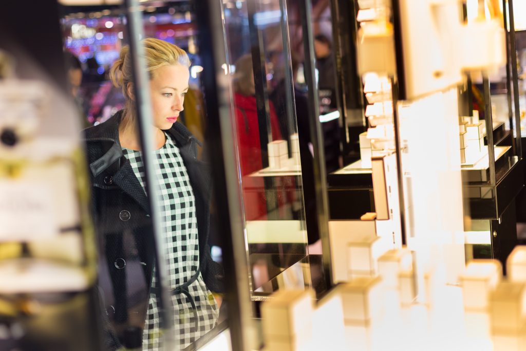 beautiful woman looking perfume store