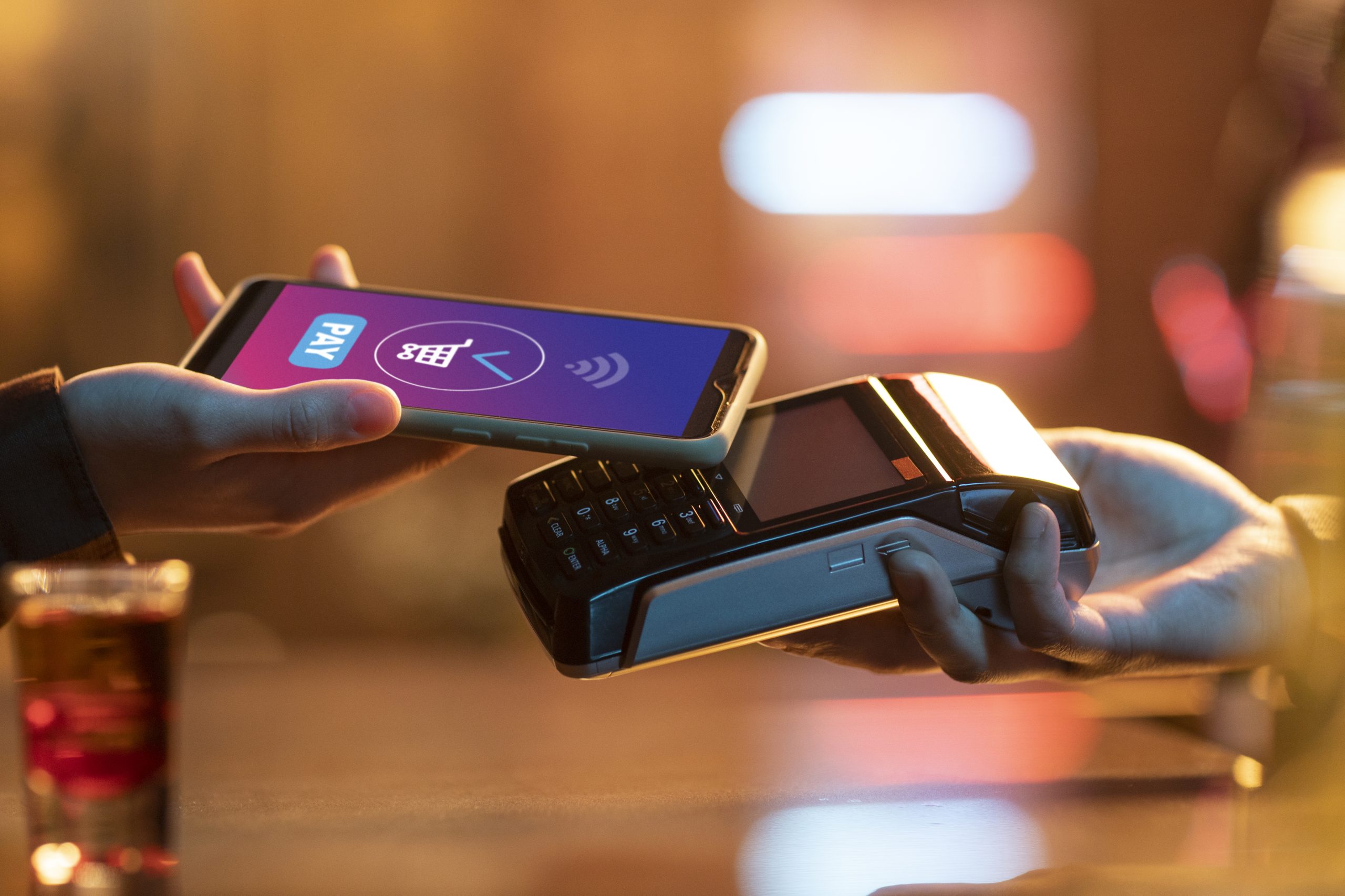 side view adult paying with card scaled